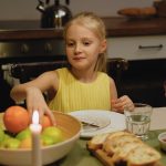 A family shares dinner together, highlighting warmth and togetherness across generations.