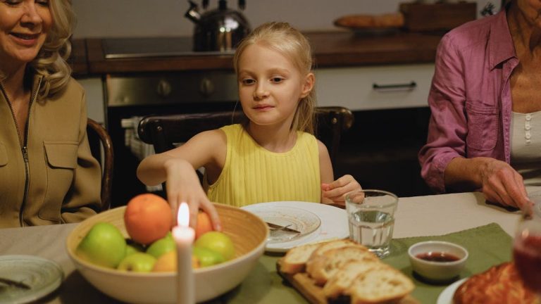A family shares dinner together, highlighting warmth and togetherness across generations.